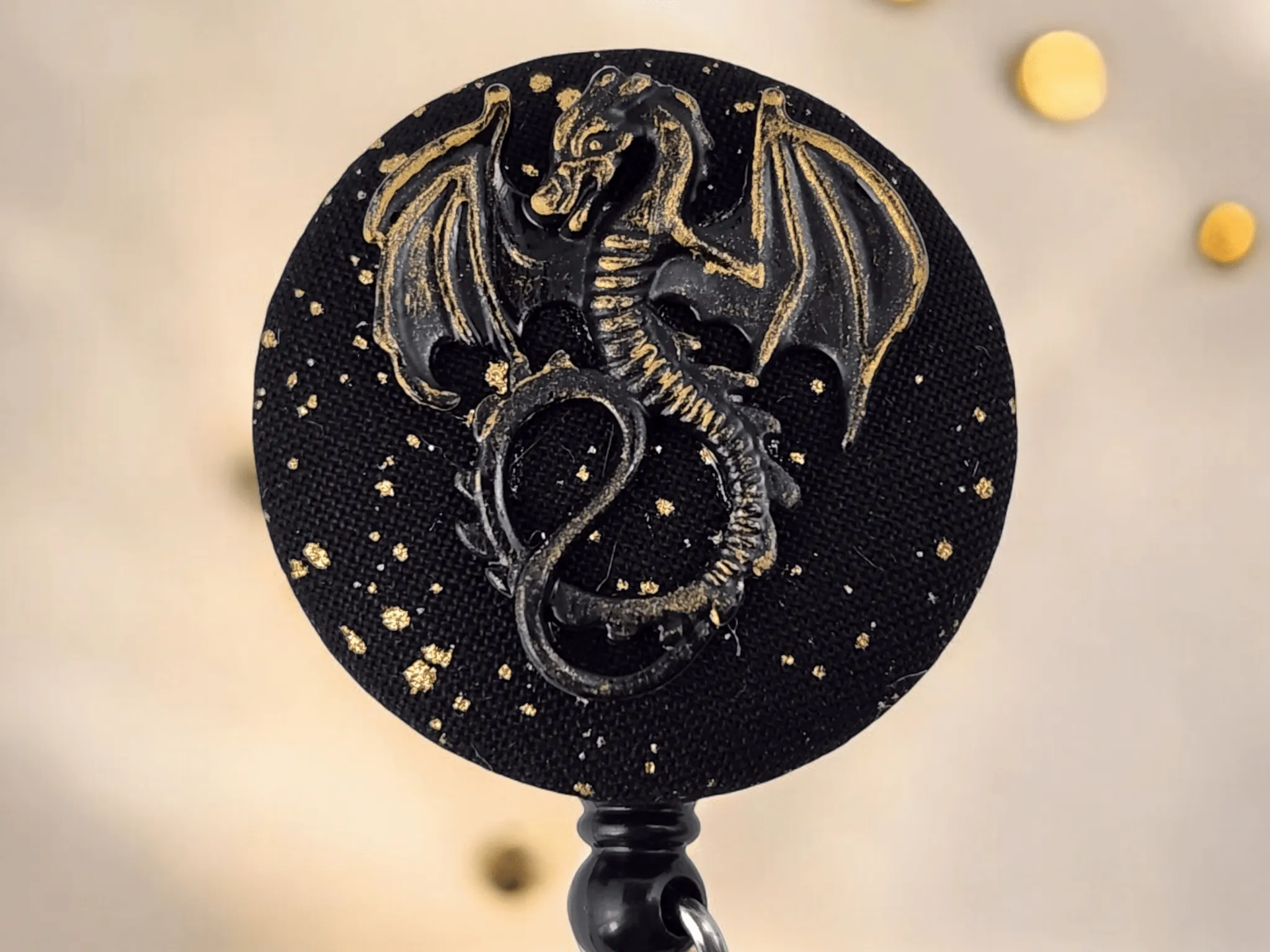 Black and gold dragon badge reel