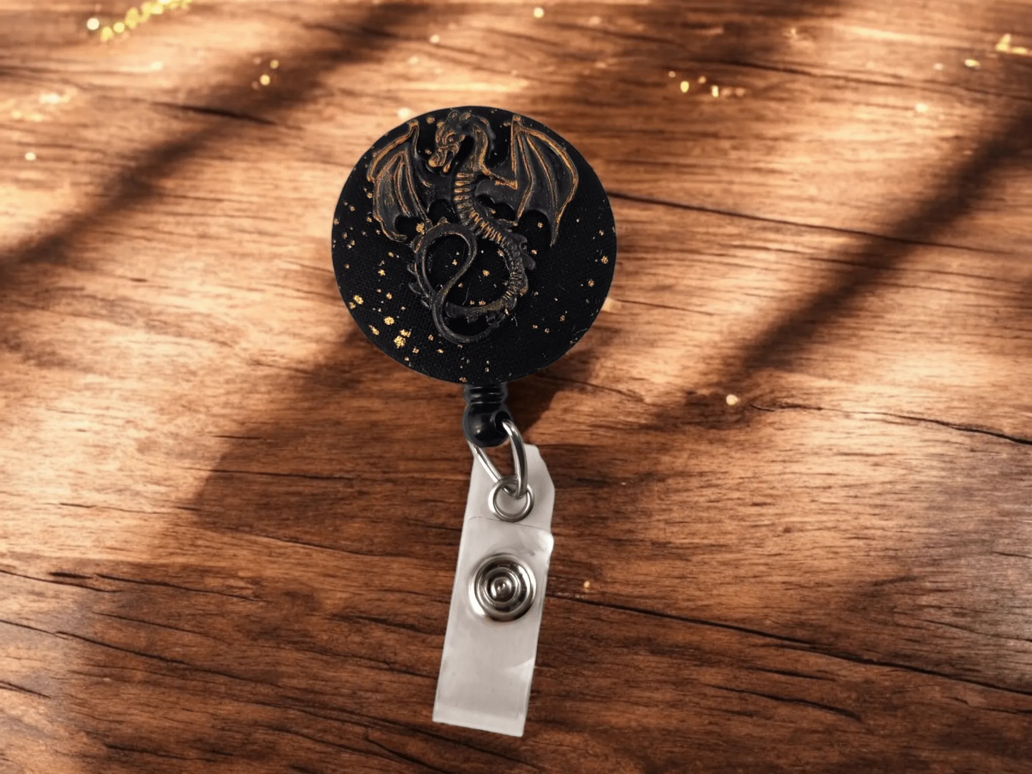 Black and gold dragon badge reel
